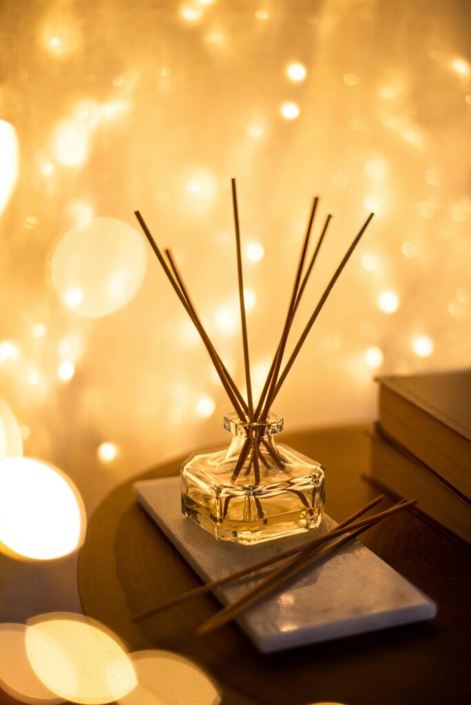 pexels-photo-14766418-14766418 A decorative reed diffuser with a bokeh light background, creating a warm cozy fall atmosphere.
