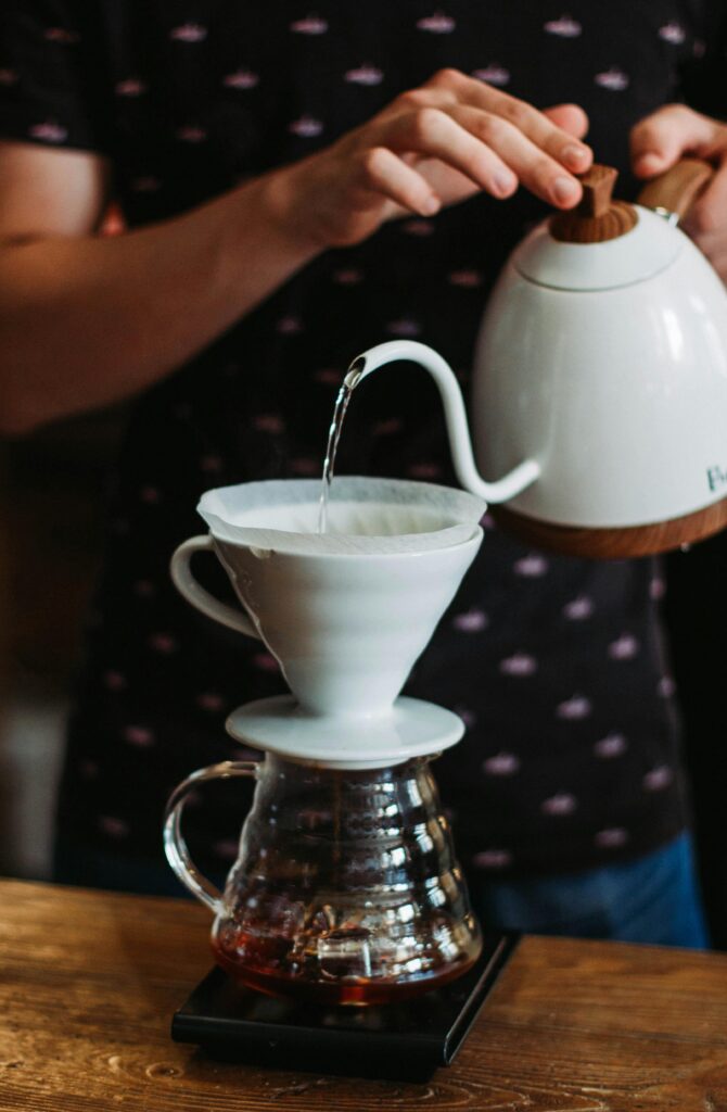 pexels-photo-2775859-2775859 Artistic close-up of pour-over coffee brewing with ceramic kettle and filter at home.